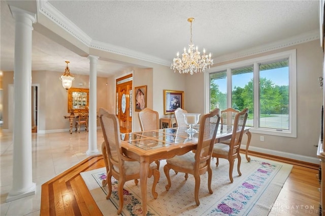 655 Devanshae Ct, Hamilton, OH 45013 - dining room featuring ornate columns, a chandelier, ornamental molding, a textured ceiling, and light wood-style floors