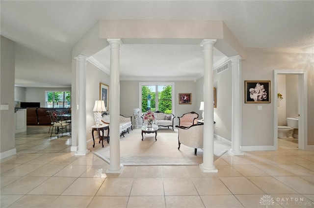 655 Devanshae Ct, Hamilton, OH 45013 - living room featuring crown molding, healthy amount of natural light, light tile patterned flooring, and decorative columns