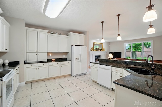 655 Devanshae Ct, Hamilton, OH 45013 - kitchen with white appliances, a fireplace, pendant lighting, white cabinets, and a textured ceiling