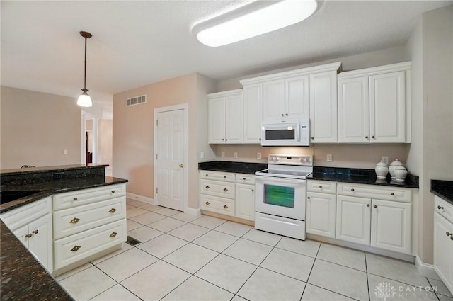 655 Devanshae Ct, Hamilton, OH 45013 - kitchen featuring white appliances, decorative light fixtures, white cabinets, light tile patterned flooring, and dark stone countertops