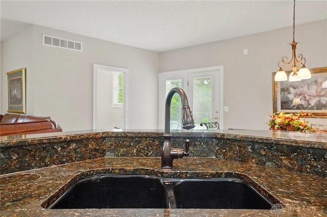 655 Devanshae Ct, Hamilton, OH 45013 - kitchen view of dark stone countertops and decorative light fixtures