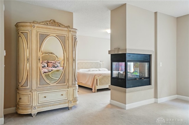 655 Devanshae Ct, Hamilton, OH 45013 - carpeted bedroom featuring a multi sided fireplace and a textured ceiling