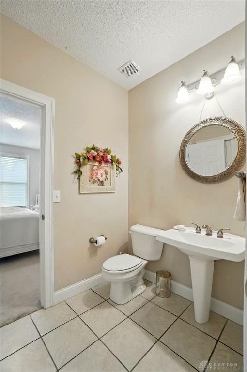 655 Devanshae Ct, Hamilton, OH 45013 - bathroom with a textured ceiling and tile patterned flooring