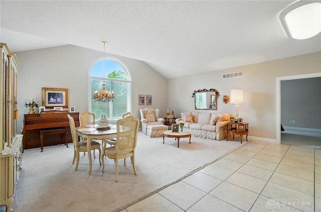 655 Devanshae Ct, Hamilton, OH 45013 - dining room featuring light carpet, vaulted ceiling, light tile patterned floors, and a chandelier
