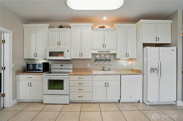 655 Devanshae Ct, Hamilton, OH 45013 - kitchen with white appliances, white cabinets, and a textured ceiling