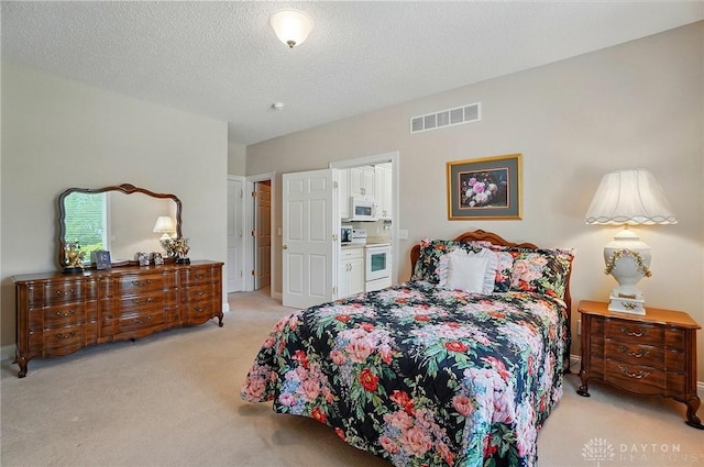 655 Devanshae Ct, Hamilton, OH 45013 - bedroom with light colored carpet, a textured ceiling, and ensuite bath