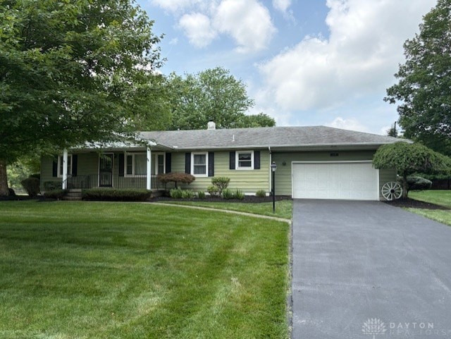 12 Henrick Dr, Middletown, OH 45044 - single story home with covered porch, driveway, a garage, and a front lawn
