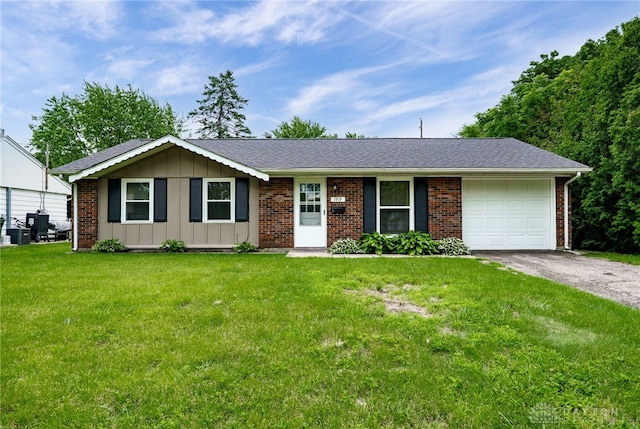 1919 Atkinson Dr, Xenia, OH 45385 - ranch-style home featuring board and batten siding, a garage, asphalt driveway, a front yard, and brick siding