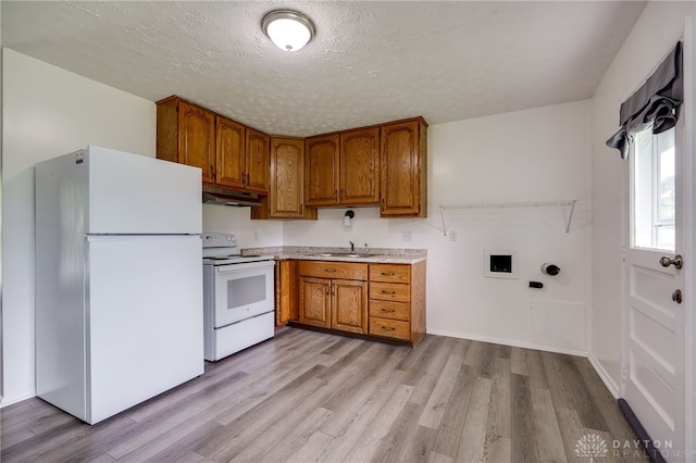 1919 Atkinson Dr, Xenia, OH 45385 - kitchen featuring white appliances, brown cabinets, under cabinet range hood, light countertops, and light wood-style flooring