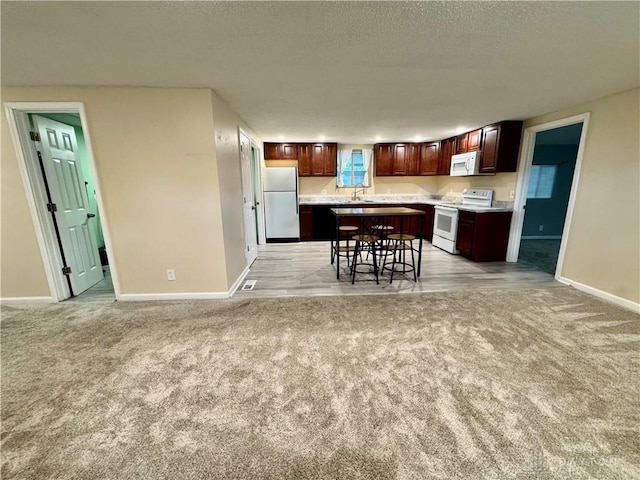 3626 Merwin 10 Mile Rd, Oh, OH 45245 - kitchen featuring white appliances, light carpet, light countertops, and a textured ceiling