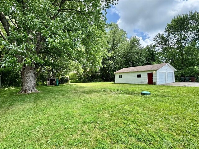 3626 Merwin 10 Mile Rd, Oh, OH 45245 - view of grassy yard with a garage, an outdoor structure, and view of scattered trees