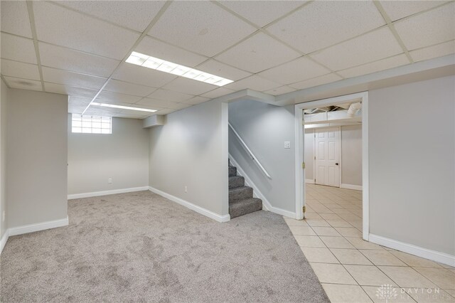 1603 Rosemont Blvd, Dayton, OH 45410 - basement featuring a paneled ceiling, stairway, carpet floors, and tile patterned flooring