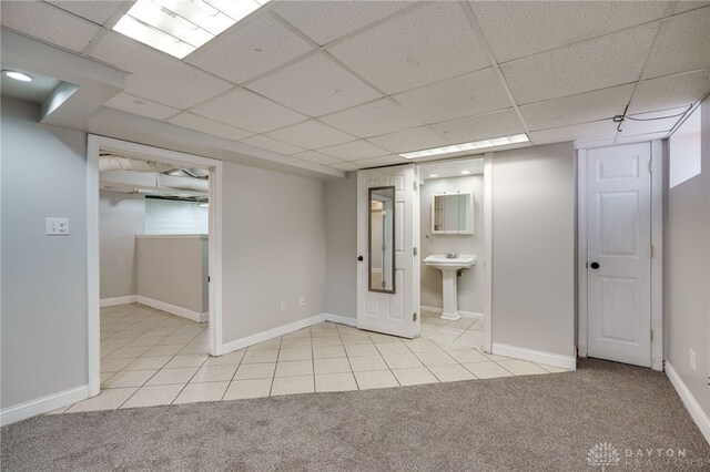 1603 Rosemont Blvd, Dayton, OH 45410 - finished basement featuring a paneled ceiling, light tile patterned floors, and light carpet
