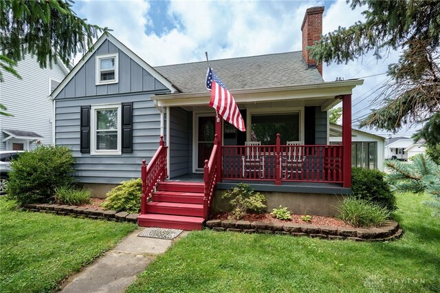 1603 Rosemont Blvd, Dayton, OH 45410 - bungalow-style home featuring a porch, board and batten siding, and a front lawn