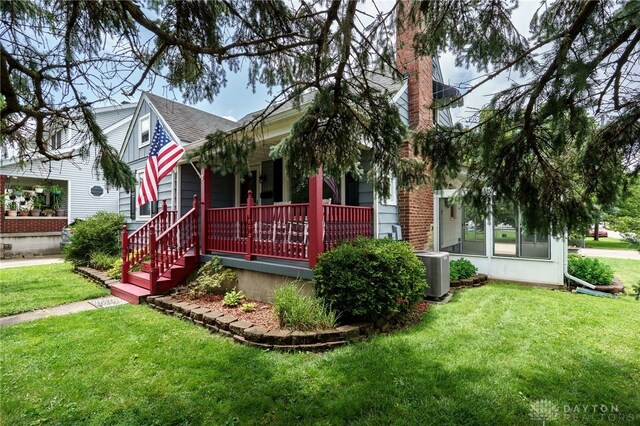 1603 Rosemont Blvd, Dayton, OH 45410 - view of front of home featuring covered porch, a front yard, roof with shingles, and a chimney