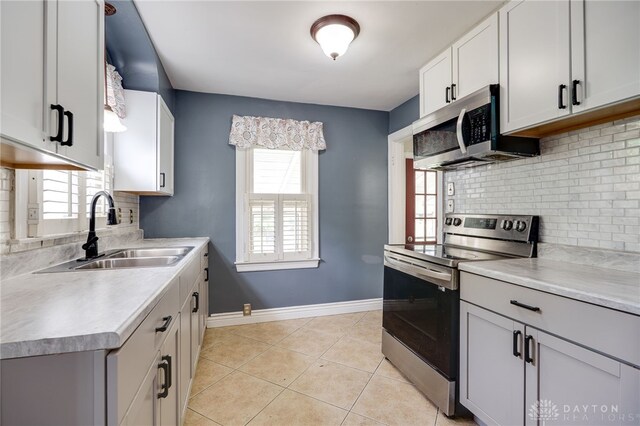 1603 Rosemont Blvd, Dayton, OH 45410 - kitchen featuring stainless steel appliances, decorative backsplash, and light countertops