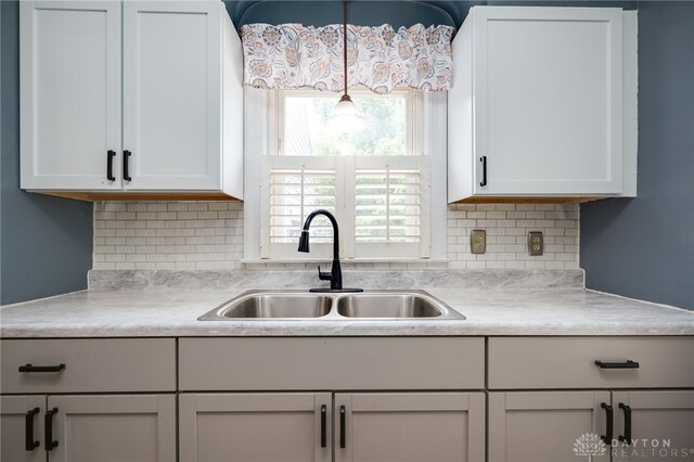 1603 Rosemont Blvd, Dayton, OH 45410 - kitchen featuring light countertops, tasteful backsplash, white cabinetry, and pendant lighting