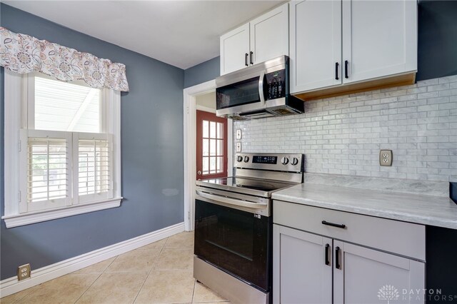 1603 Rosemont Blvd, Dayton, OH 45410 - kitchen with stainless steel appliances, light tile patterned flooring, light countertops, and backsplash