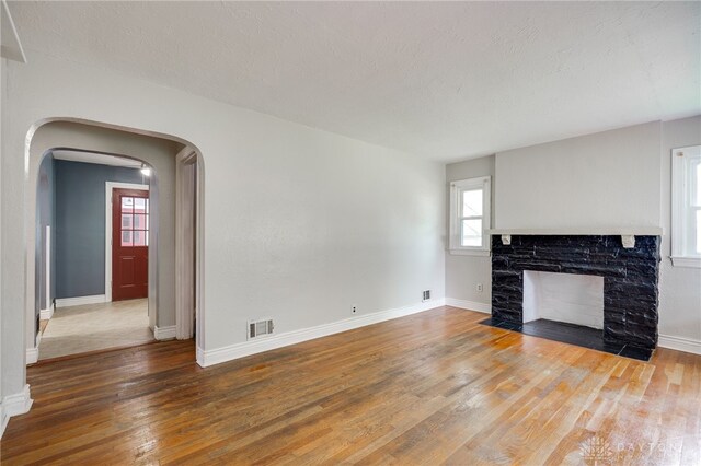 1603 Rosemont Blvd, Dayton, OH 45410 - unfurnished living room featuring arched walkways, hardwood / wood-style floors, and healthy amount of natural light