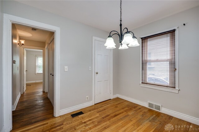 1603 Rosemont Blvd, Dayton, OH 45410 - unfurnished dining area with a chandelier and light wood finished floors