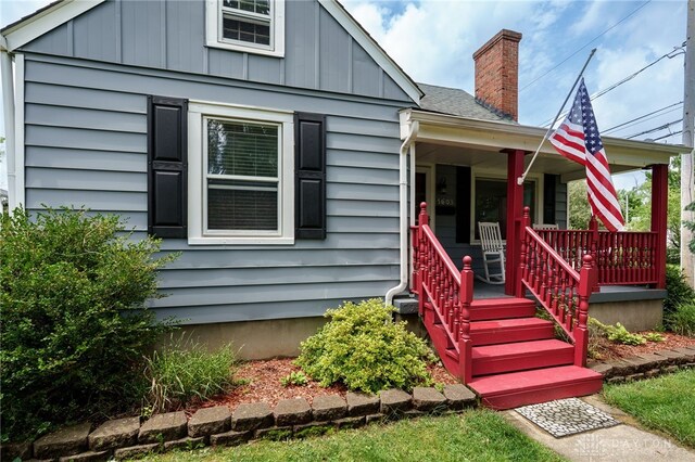 1603 Rosemont Blvd, Dayton, OH 45410 - bungalow featuring covered porch, a chimney, and board and batten siding
