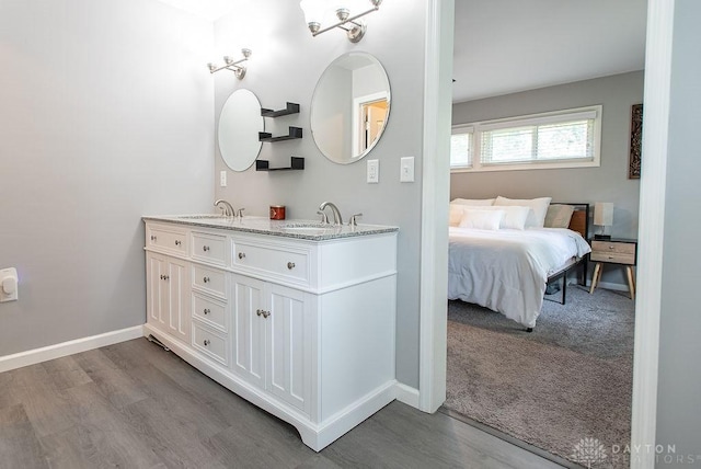 881 Garver Rd, Monroe, OH 45044 - bathroom featuring double vanity and wood finished floors