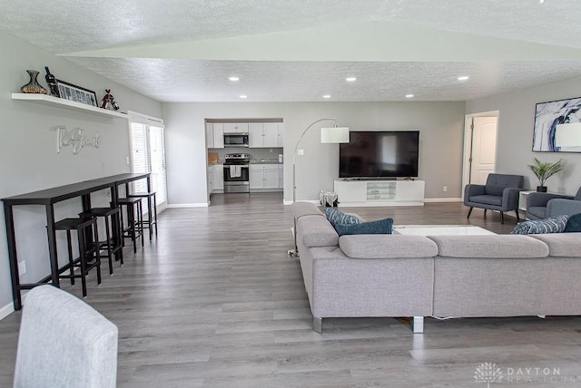 881 Garver Rd, Monroe, OH 45044 - living room featuring wood finished floors, a textured ceiling, and recessed lighting