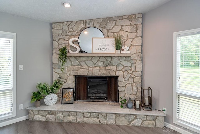 881 Garver Rd, Monroe, OH 45044 - detailed view of wood finished floors, a fireplace, and a textured ceiling