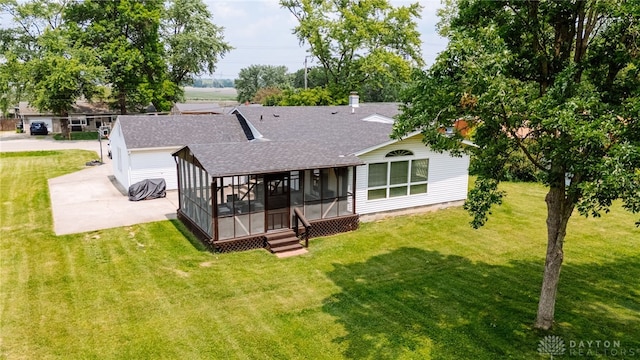 881 Garver Rd, Monroe, OH 45044 - back of house with roof with shingles, a sunroom, a yard, and concrete driveway