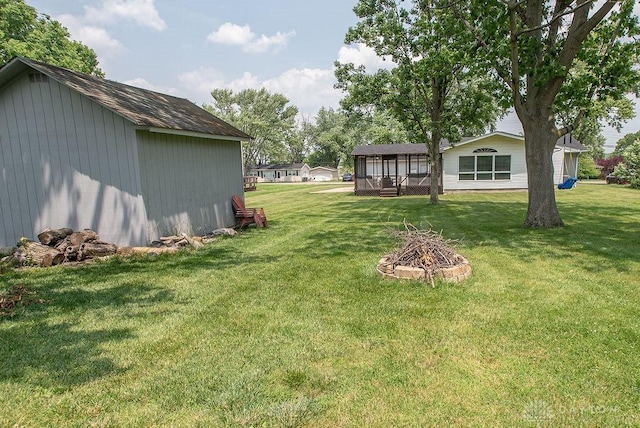 881 Garver Rd, Monroe, OH 45044 - view of grassy yard featuring an outdoor fire pit and an outdoor structure