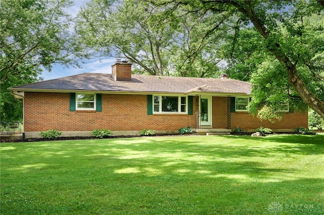 3201 Sears Rd, Spring Valley Twp, OH 45370 - ranch-style house featuring a chimney, brick siding, a front yard, and a shingled roof