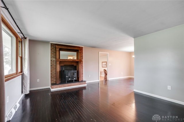 3201 Sears Rd, Spring Valley Twp, OH 45370 - unfurnished living room with hardwood / wood-style flooring and a wood stove