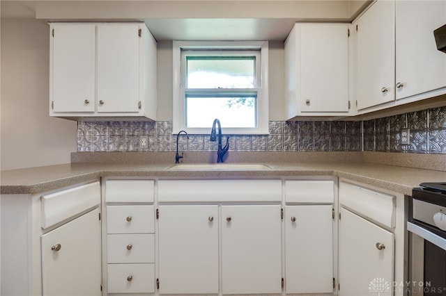 3201 Sears Rd, Spring Valley Twp, OH 45370 - kitchen featuring white cabinetry, light countertops, and backsplash