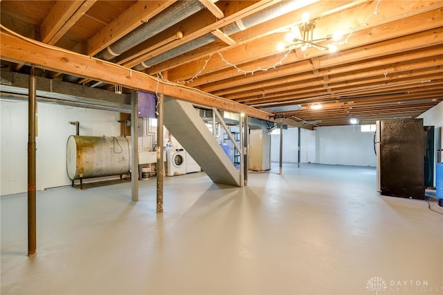 3201 Sears Rd, Spring Valley Twp, OH 45370 - unfinished basement with heating fuel, stairway, and freestanding refrigerator