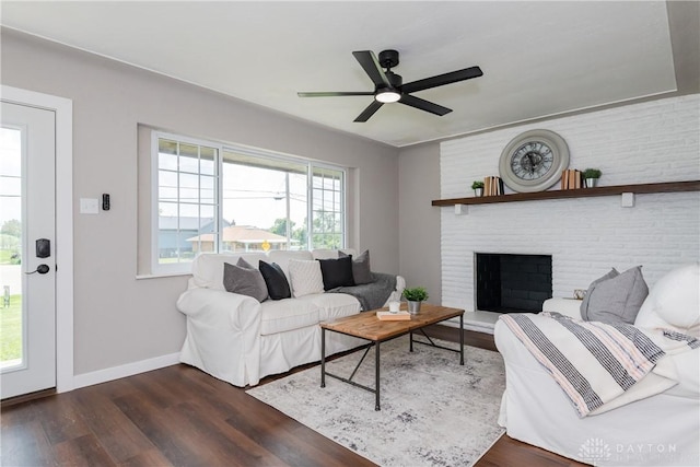 3976 Graham Dr, Beavercreek, OH 45431 - living room with dark wood finished floors, ceiling fan, and a brick fireplace