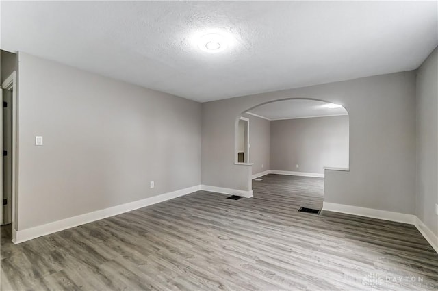 1601 Rausch Ave, Dayton, OH 45432 - unfurnished room with arched walkways, wood finished floors, and a textured ceiling