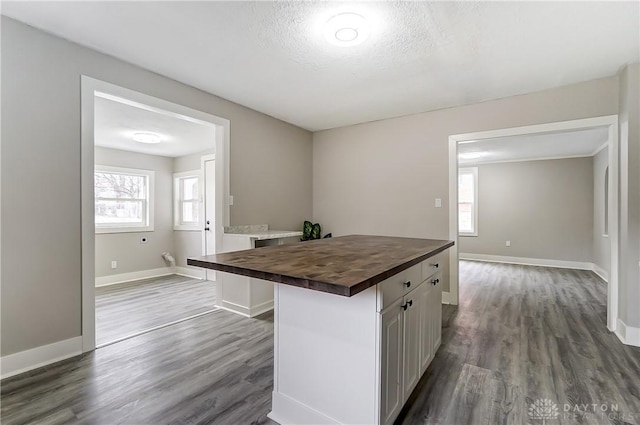 1601 Rausch Ave, Dayton, OH 45432 - kitchen with wood counters, dark wood-style floors, a kitchen island, white cabinetry, and a textured ceiling