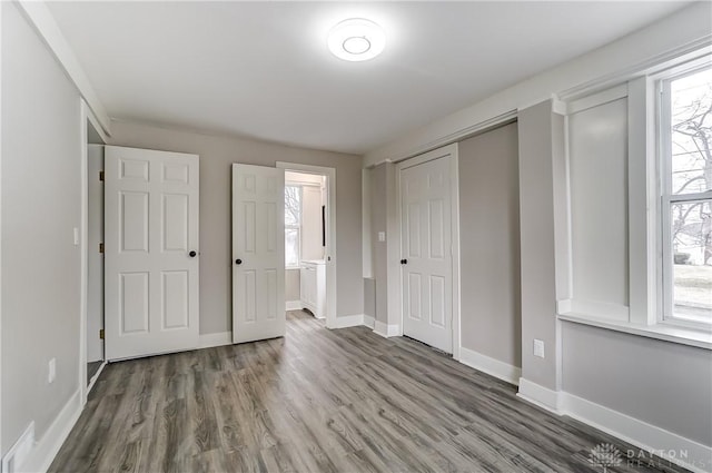 1601 Rausch Ave, Dayton, OH 45432 - unfurnished bedroom with multiple windows, wood finished floors, and ensuite bath