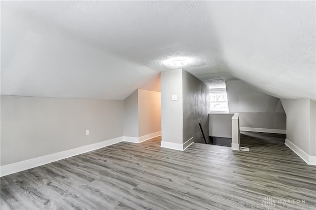1601 Rausch Ave, Dayton, OH 45432 - additional living space with vaulted ceiling, wood finished floors, and a textured ceiling