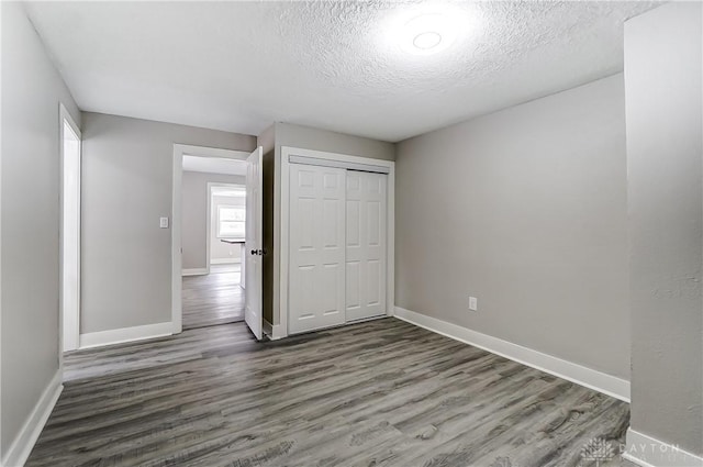 1601 Rausch Ave, Dayton, OH 45432 - unfurnished bedroom featuring wood finished floors, a closet, and a textured ceiling