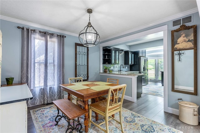 195 Sycamore Creek Dr, Springboro, OH 45066 - dining space featuring a chandelier, ornamental molding, and wood finished floors
