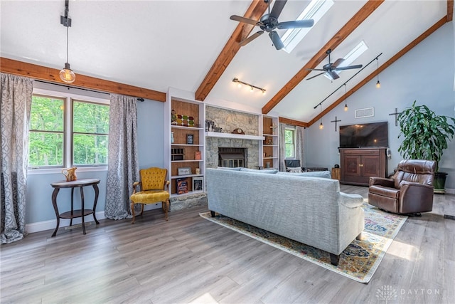 195 Sycamore Creek Dr, Springboro, OH 45066 - living area with a ceiling fan, beam ceiling, high vaulted ceiling, a fireplace, and light wood-type flooring