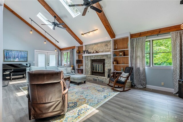 195 Sycamore Creek Dr, Springboro, OH 45066 - living area featuring ceiling fan, a skylight, beam ceiling, wood finished floors, and high vaulted ceiling