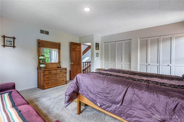 195 Sycamore Creek Dr, Springboro, OH 45066 - carpeted bedroom featuring multiple closets and a textured ceiling