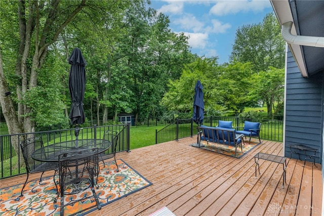 195 Sycamore Creek Dr, Springboro, OH 45066 - deck with outdoor dining space, view of wooded area, an outdoor living space, and a shed