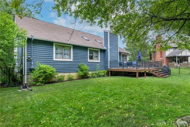 195 Sycamore Creek Dr, Springboro, OH 45066 - back of house with a deck, a chimney, and a shingled roof