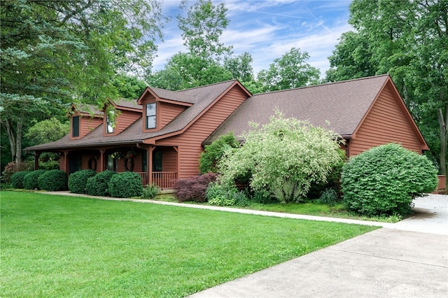 4911 Arabian Dr, Fairborn, OH 45324 - view of front of home with a porch, a front lawn, concrete driveway, and a shingled roof