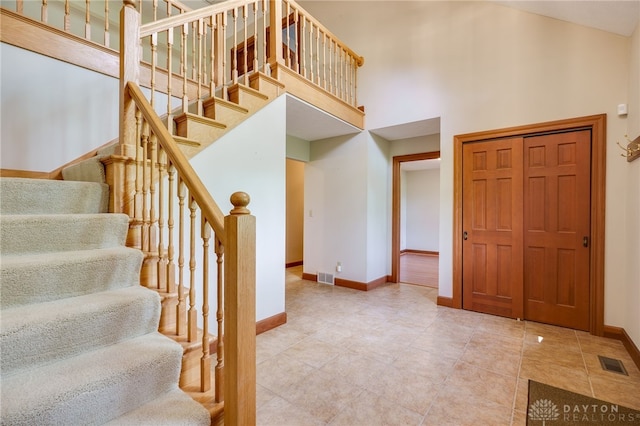 4911 Arabian Dr, Fairborn, OH 45324 - staircase featuring a towering ceiling and tile patterned flooring