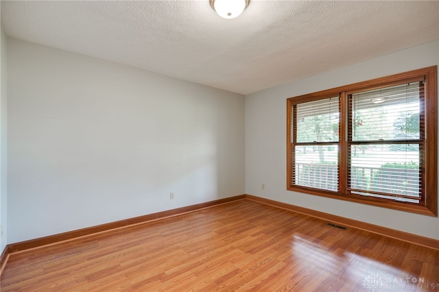 4911 Arabian Dr, Fairborn, OH 45324 - empty room with light wood finished floors and a textured ceiling