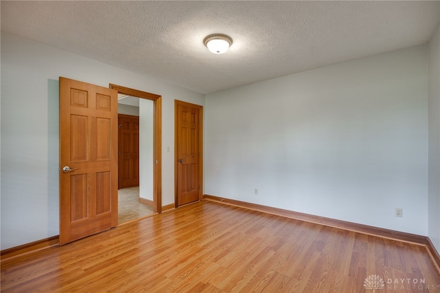 4911 Arabian Dr, Fairborn, OH 45324 - unfurnished room with light wood-type flooring and a textured ceiling